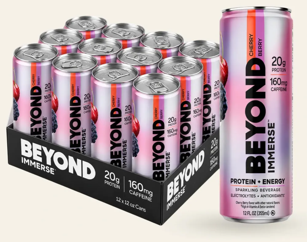 A pink-and-purple Beyond Immerse Protein + Energy can is shown beside a tray of matching cans