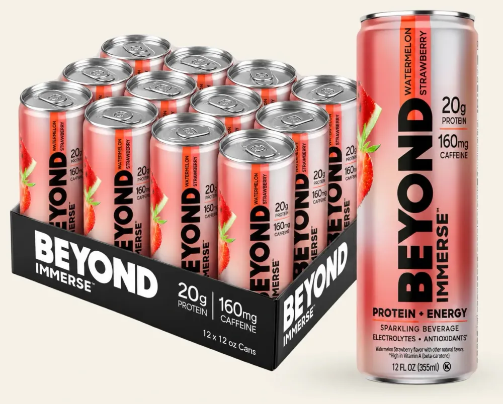 A group of slim pink cans of Beyond Immerse Protein + Energy is arranged in a black display tray, with one can shown prominently at right