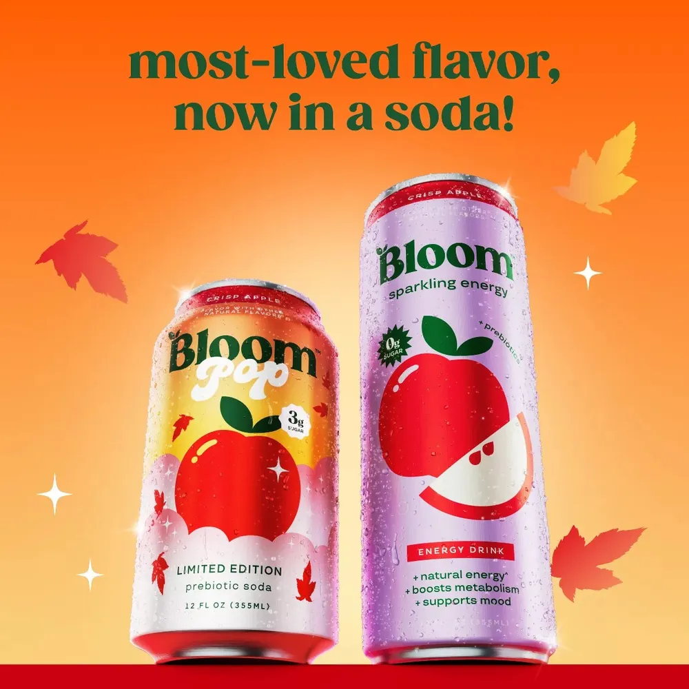 Bloom Pop Crisp Apple prebiotic soda and Bloom Sparkling Energy Crisp Apple cans side by side on an autumn background under the line 'most-loved flavor, now in a soda!'