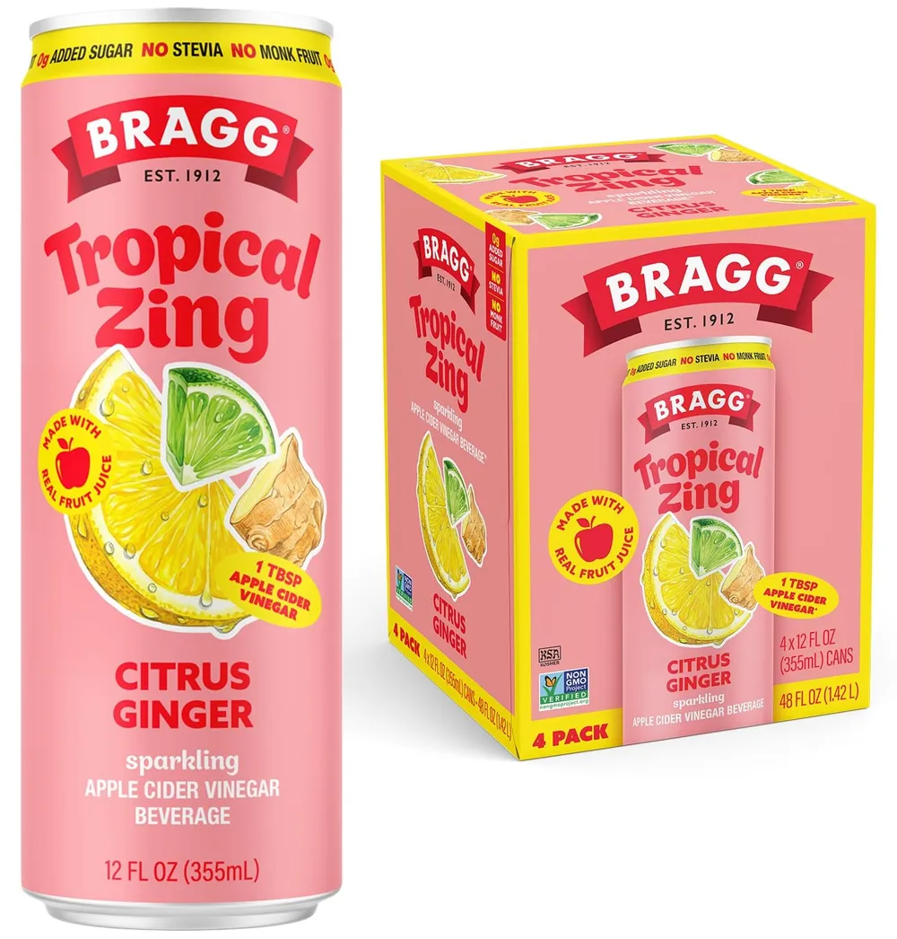 A pink Bragg Tropical Zing Citrus Ginger sparkling apple cider vinegar can beside its matching four-pack carton