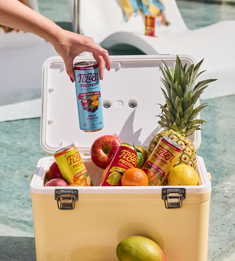Fizzen Sparkling Fruit Juice Protein cans in a poolside cooler