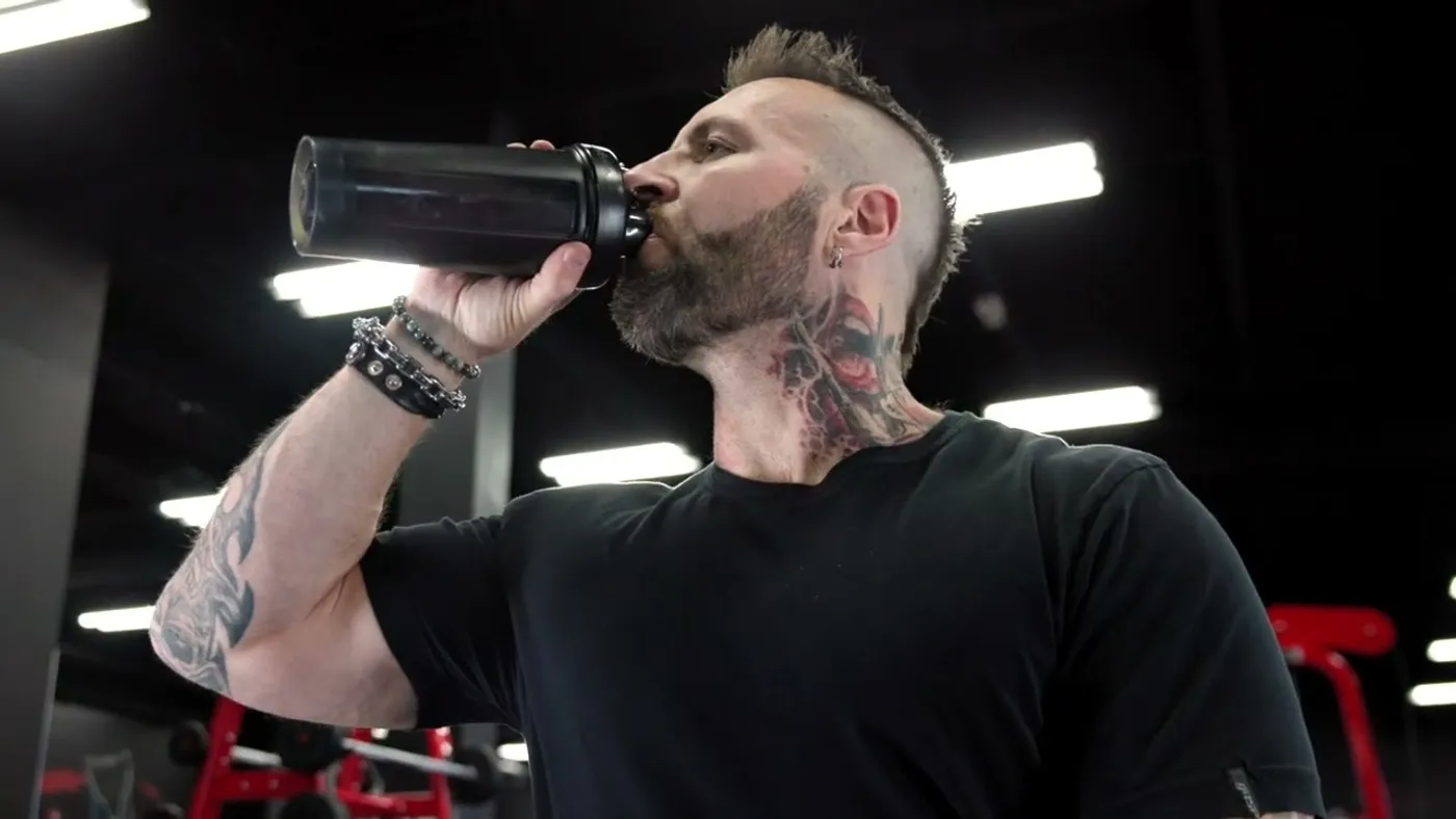 Kris Gethin drinking from a shaker bottle