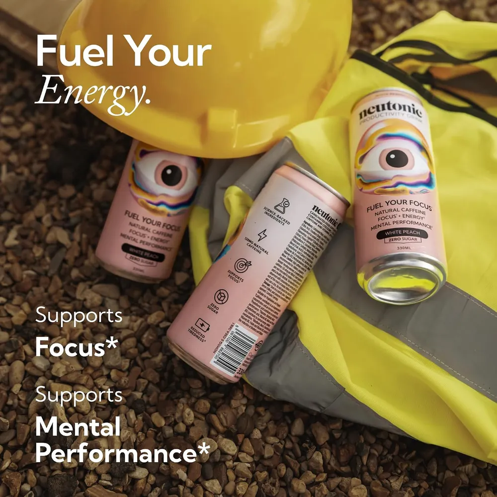Three Neutonic White Peach cans lying on a high-visibility work vest next to a yellow hard hat