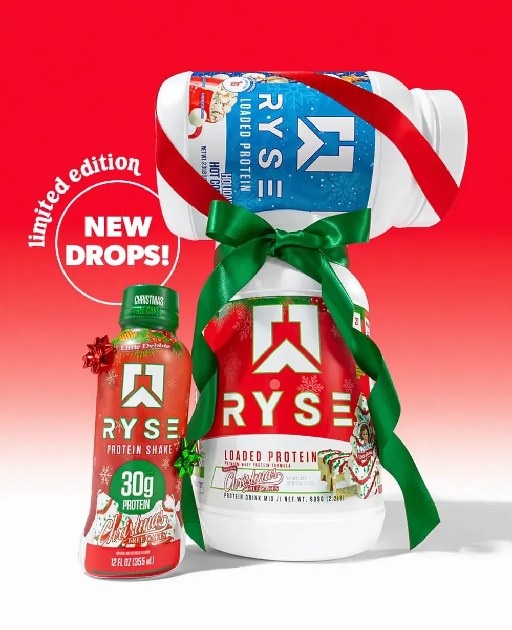 RYSE's Little Debbie holiday drops banner showing the Christmas Tree Cakes protein shake bottle next to a ribbon-tied bag of Loaded Protein powder