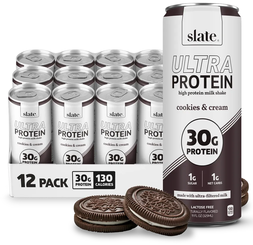 A Slate Ultra Protein high-protein milk shake can is shown in front of a 12-pack carton, with several cans visible behind it