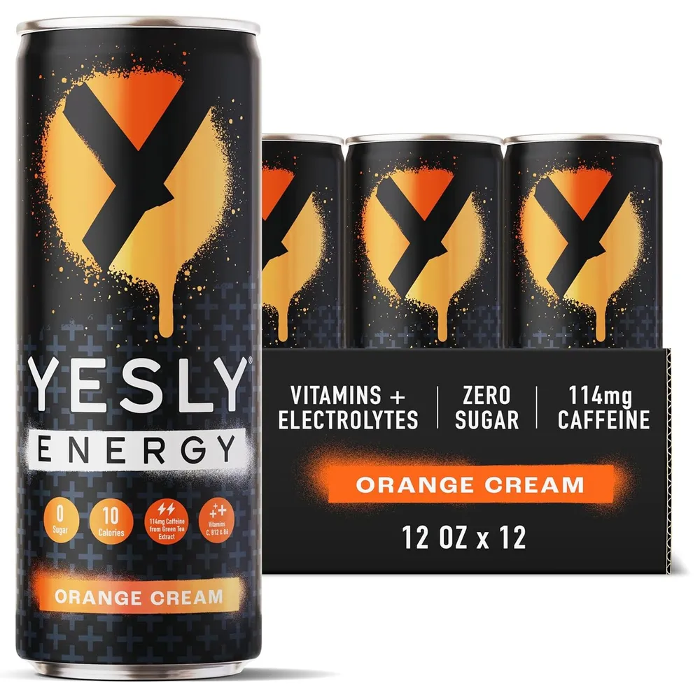 A Yesly Energy Orange Cream can with orange-and-yellow graphics in front of its 12-can case